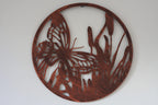 Decorative metal wall art with butterfly design on a white background