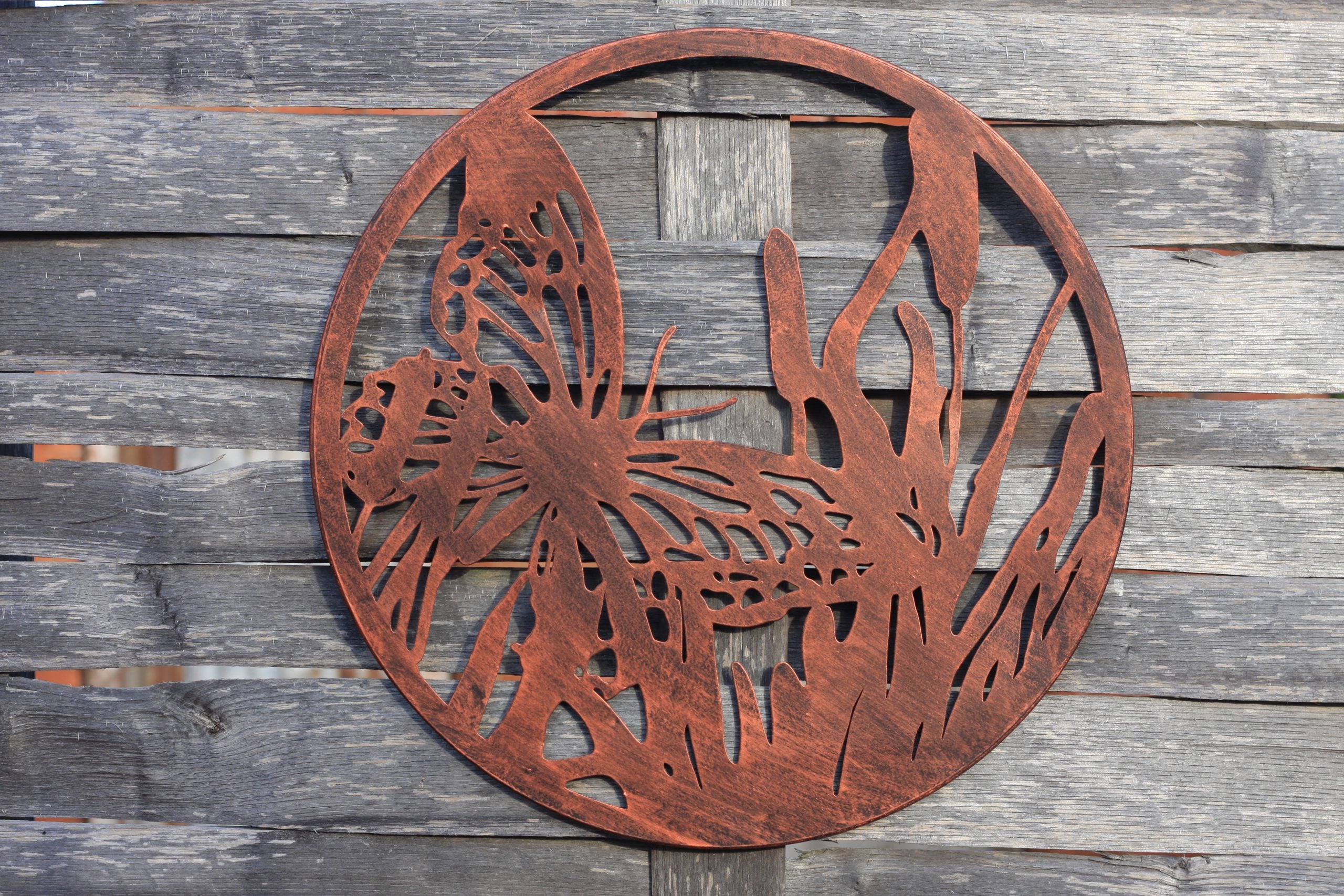 copper bronze wall art hanging on wooden wall