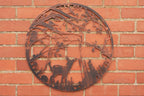 Decorative metal wall art with deer and nature elements on a brick wall