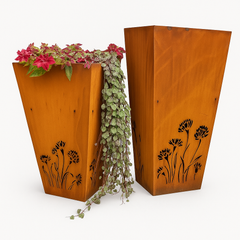 Two wooden planters with floral designs and plants on a white background