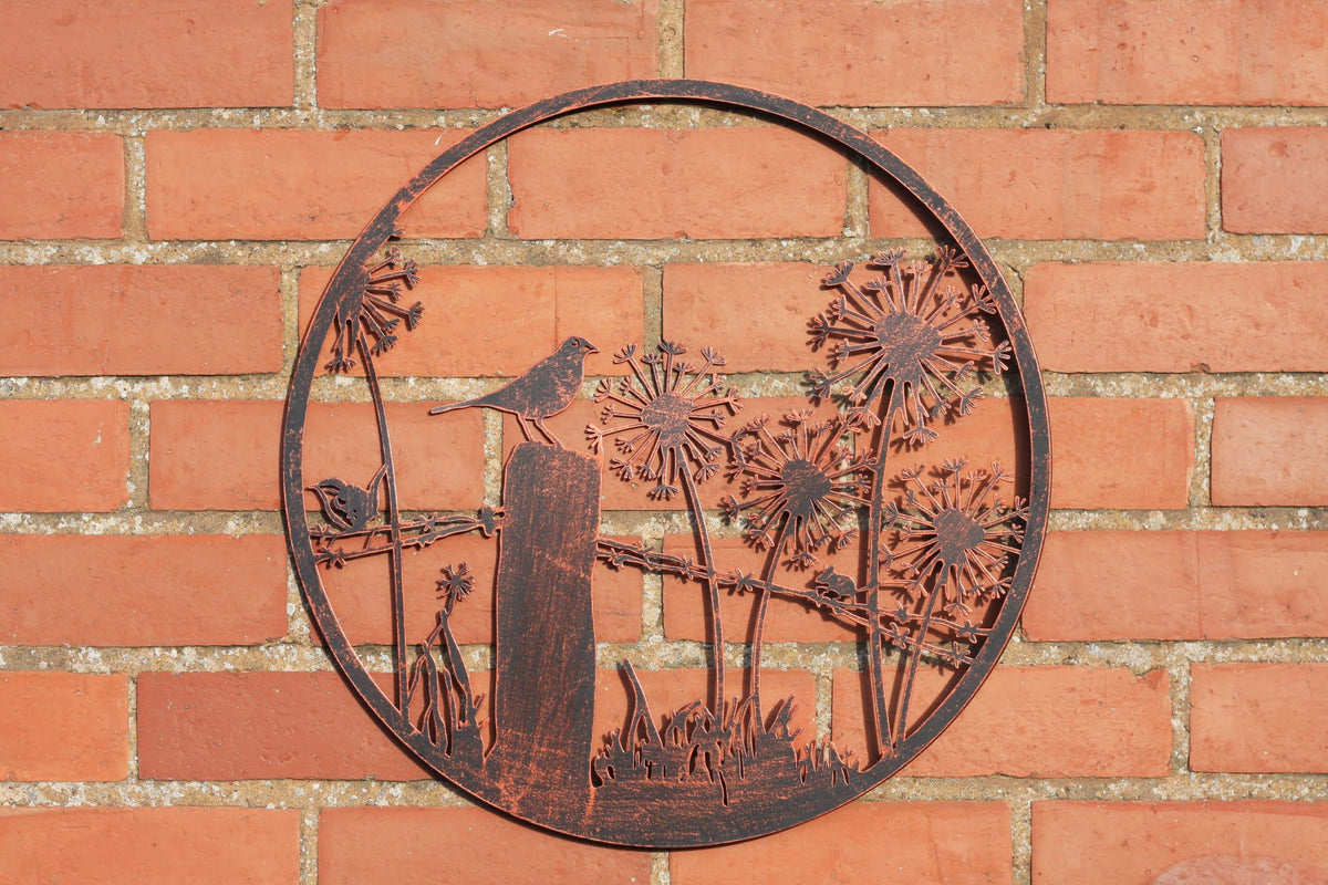 Decorative metal wall art with birds and flowers on a brick wall