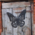 bee and hive colourful metal wall art on wooden background next to brick wall