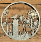 Decorative metal wall art with birds and flowers on a wooden background